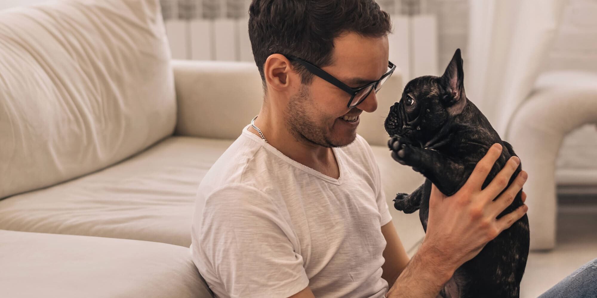 Man holding French Bulldog